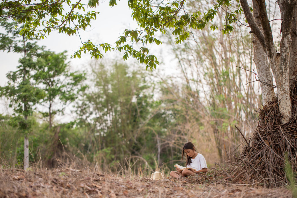 Child reading outside