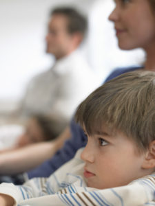 boy and family watching TV at hotel