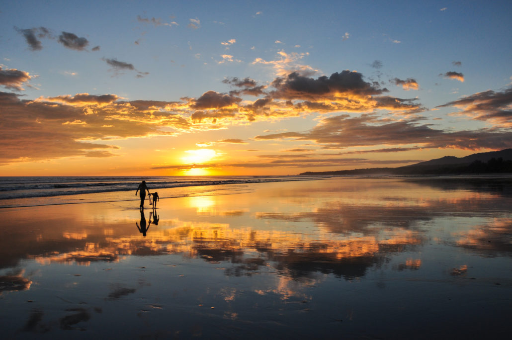 parent and child on beach in El Salvador