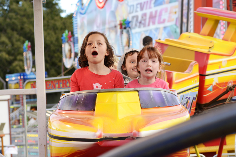 Young kids on a carnival ride 